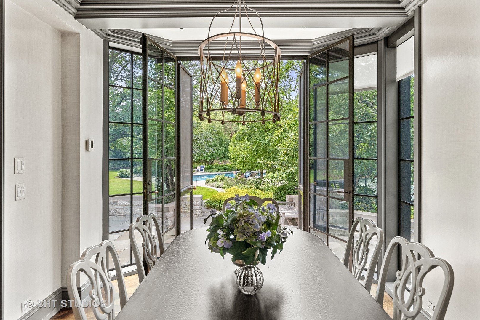 720 Ardsley Road Winnetka, IL 60093 - Photo 89 of 103 a dining room with furniture water view and a chandelier