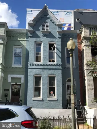 a front view of a house with parking space