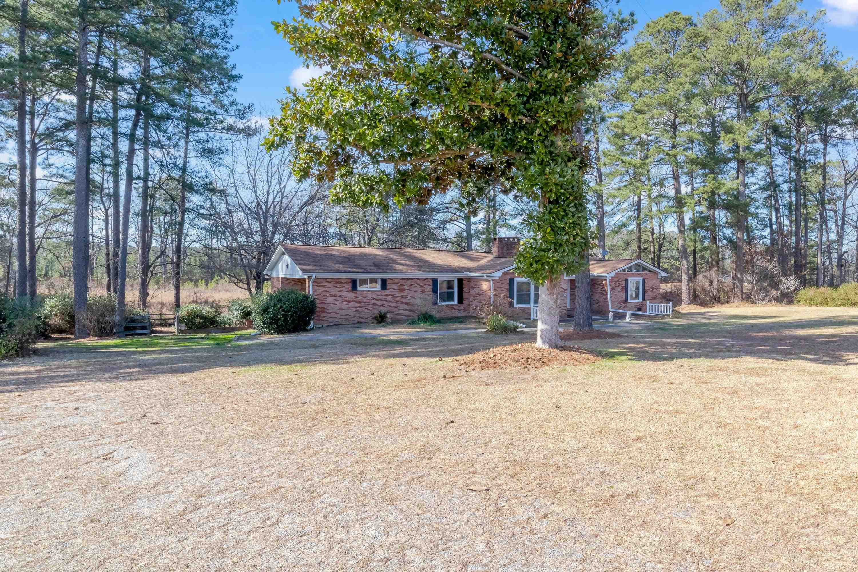 4612 Browns Pond Road Selma, NC 27576 - Photo 1 of 50 a view of a house with a yard and large trees