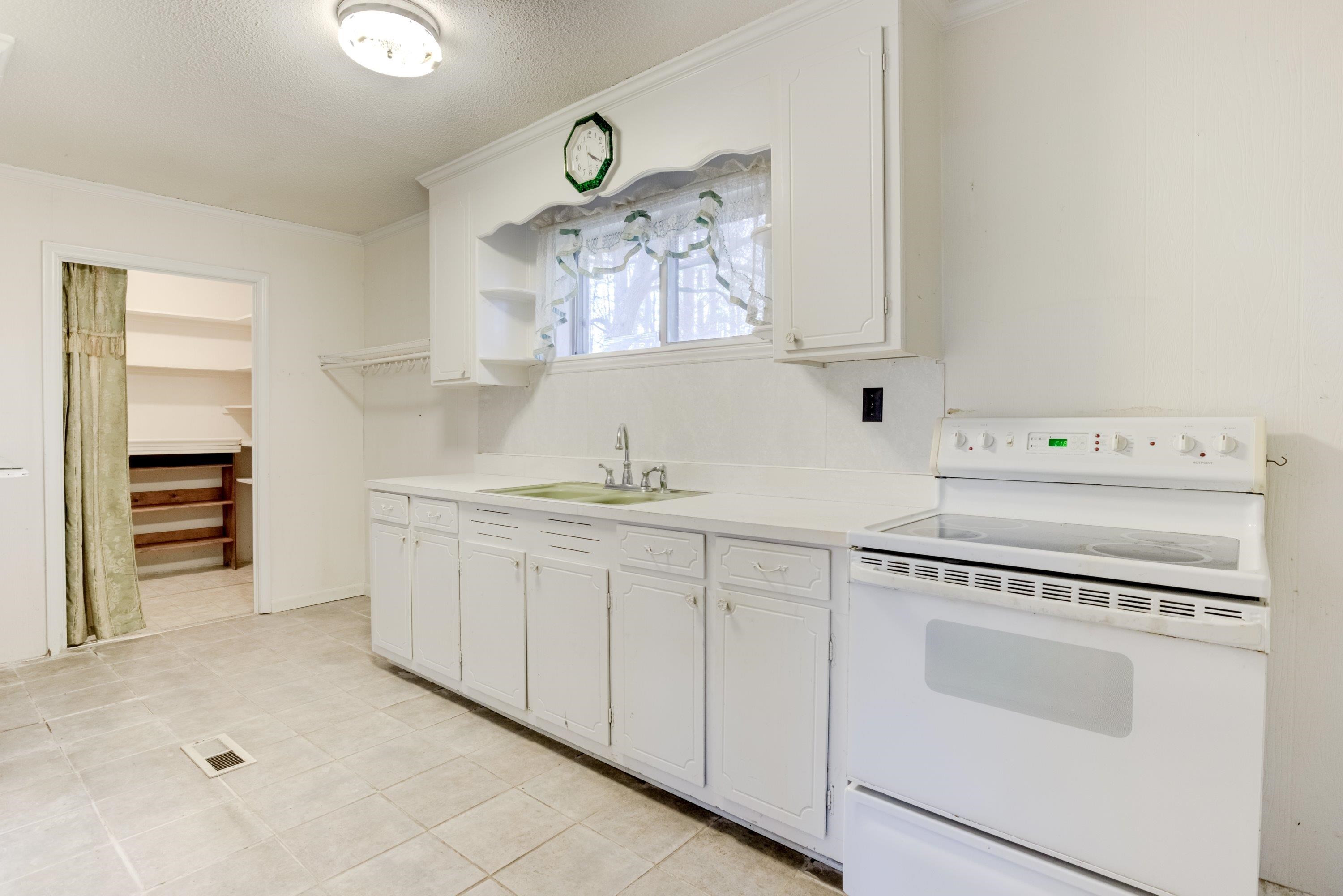 4612 Browns Pond Road Selma, NC 27576 - Photo 13 of 50 a kitchen with cabinets a washer and dryer