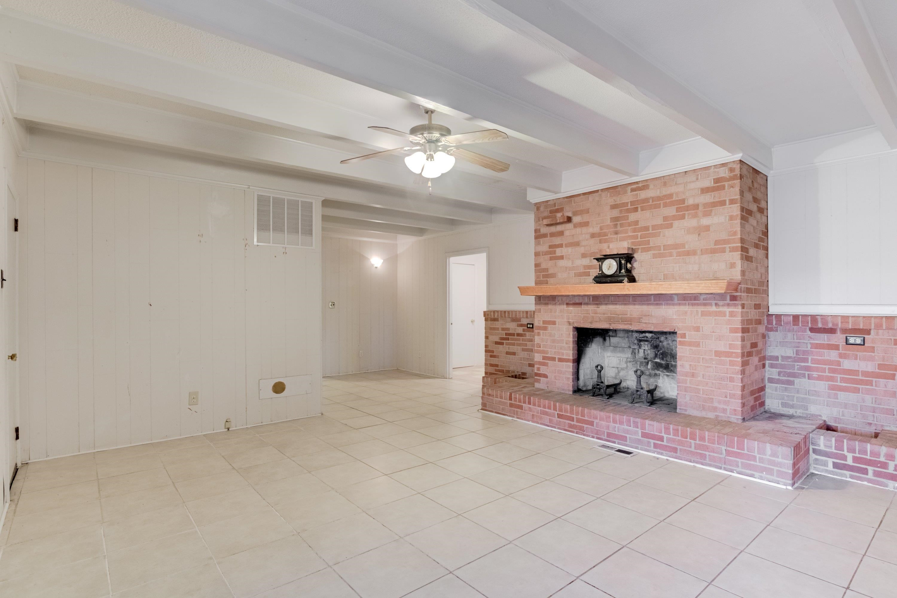 4612 Browns Pond Road Selma, NC 27576 - Photo 20 of 50 an empty room with fireplace and fan