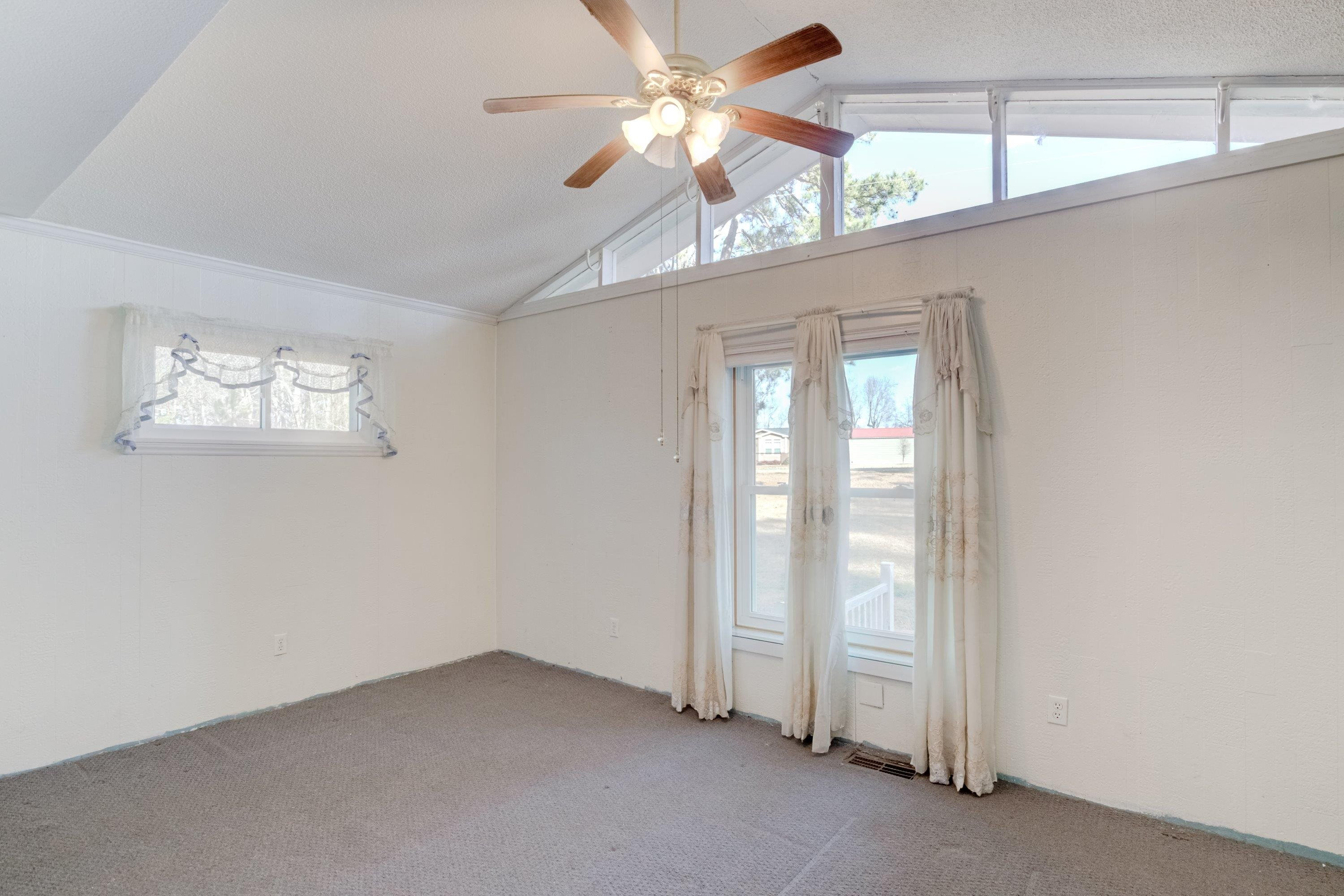 4612 Browns Pond Road Selma, NC 27576 - Photo 26 of 50 an empty room with windows and fan