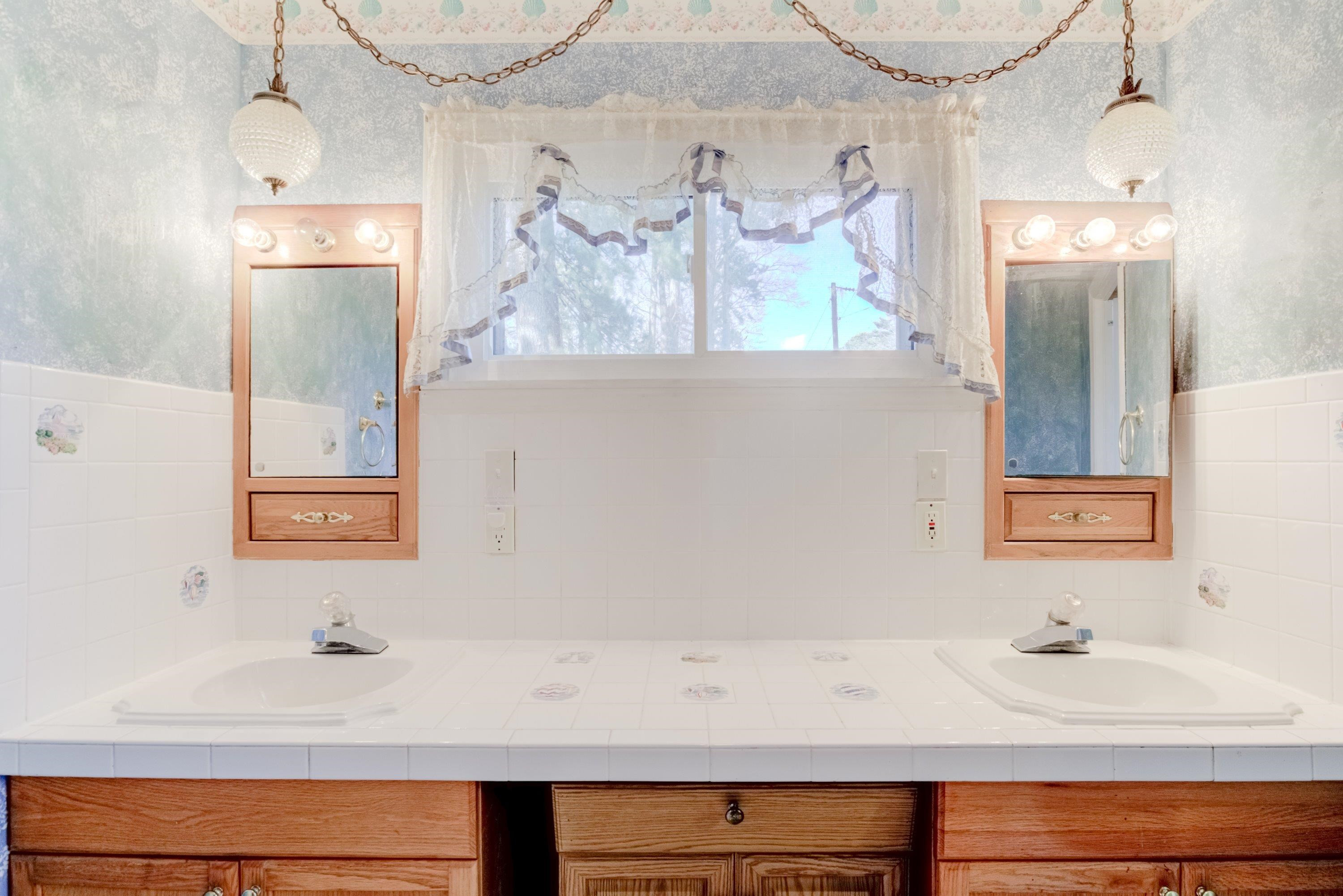 4612 Browns Pond Road Selma, NC 27576 - Photo 29 of 50 a bathroom with a sink a mirror and a window