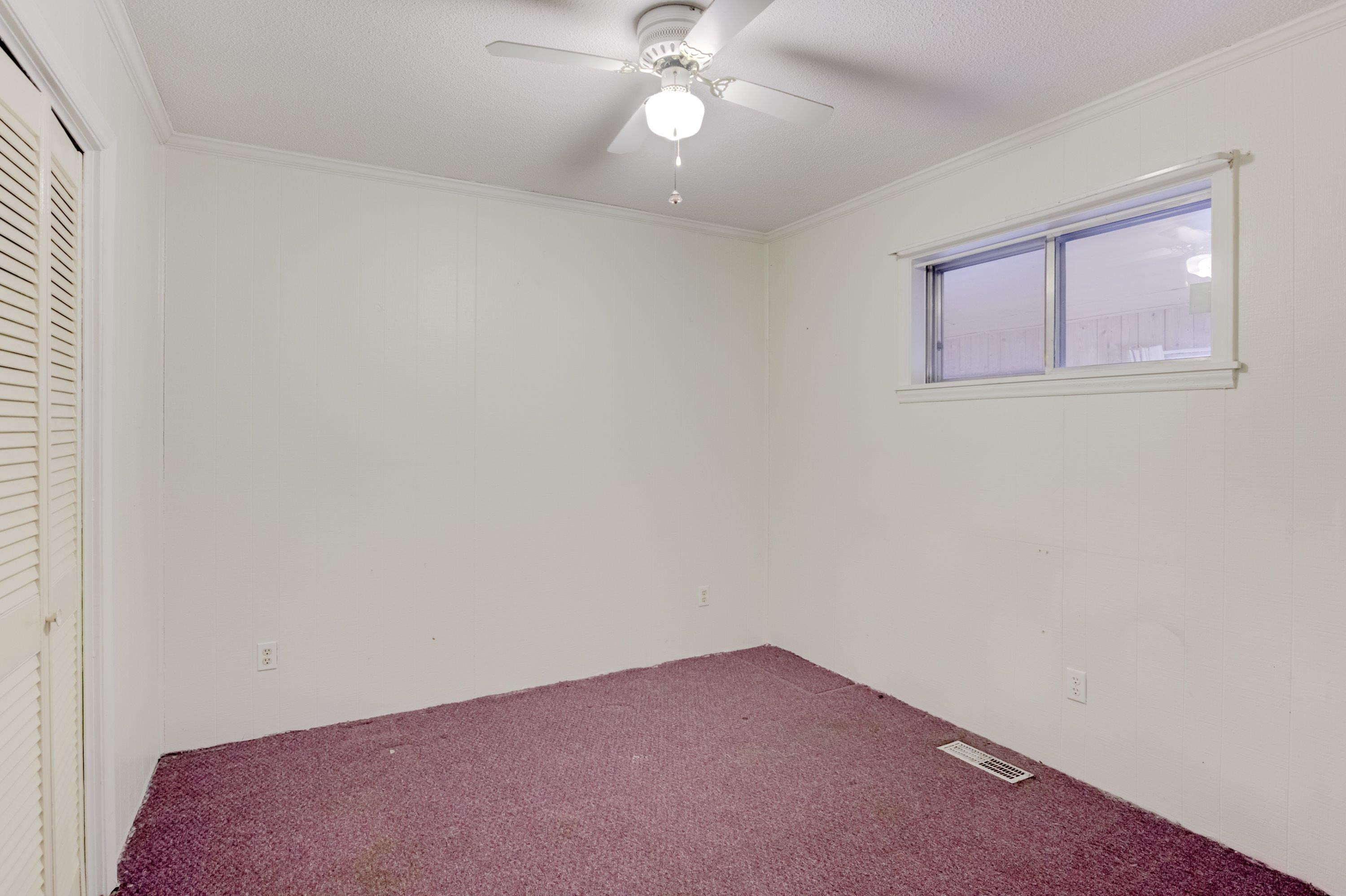 4612 Browns Pond Road Selma, NC 27576 - Photo 33 of 50 an empty room with a chandelier fan and closet area