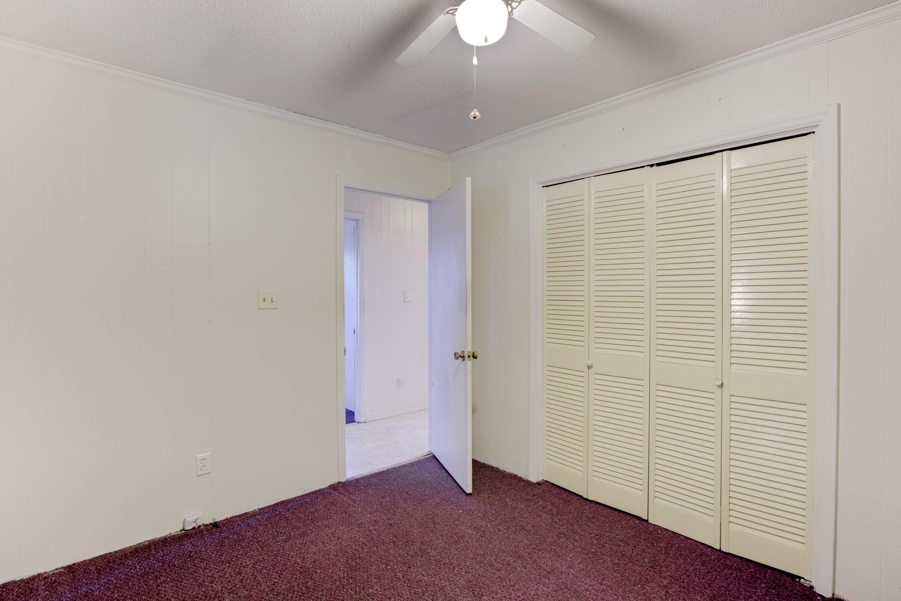 4612 Browns Pond Road Selma, NC 27576 - Photo 34 of 50 an empty room with a ceiling fan and closet area