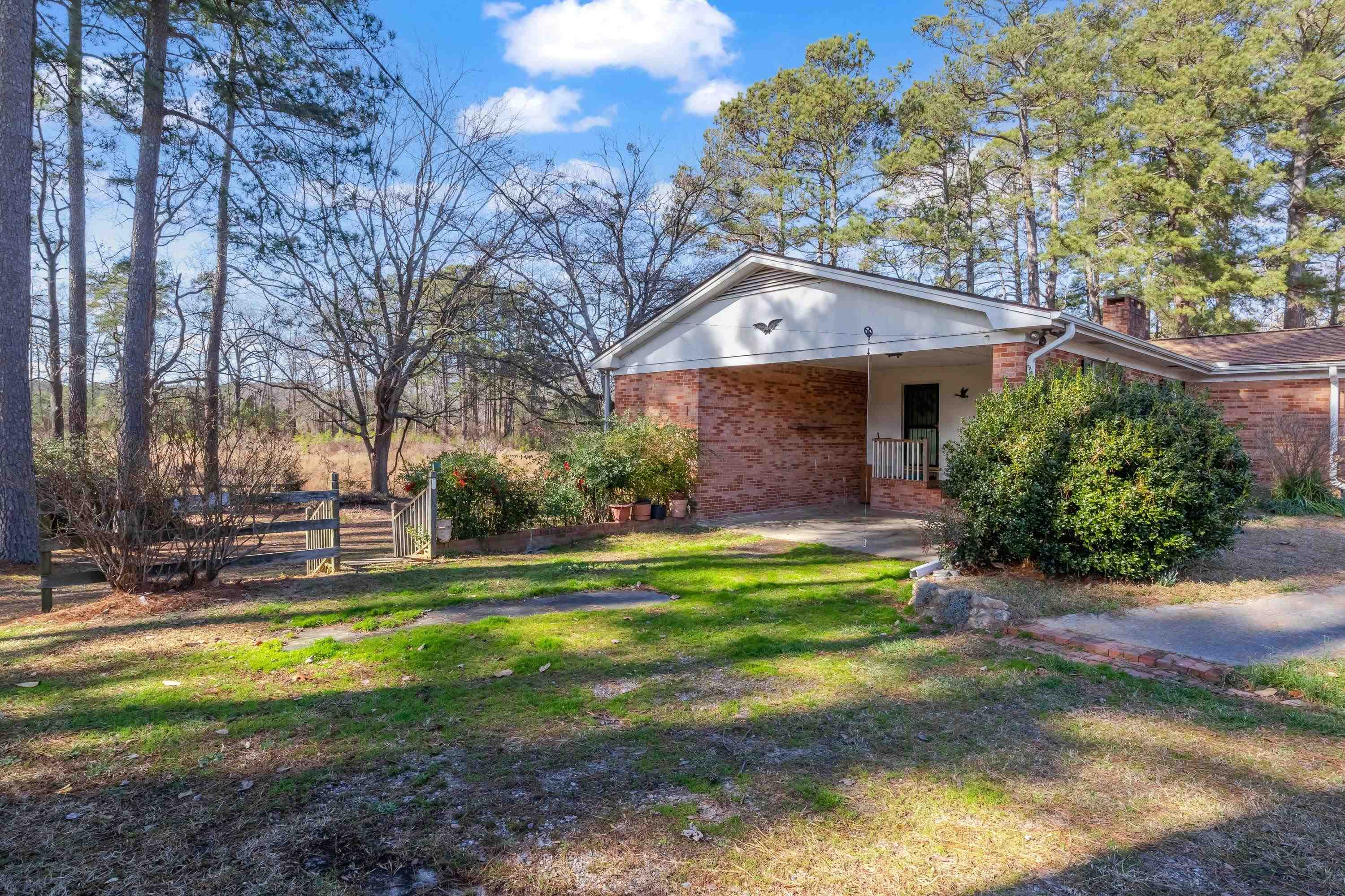 4612 Browns Pond Road Selma, NC 27576 - Photo 40 of 50 a view of a house with a big yard and large trees