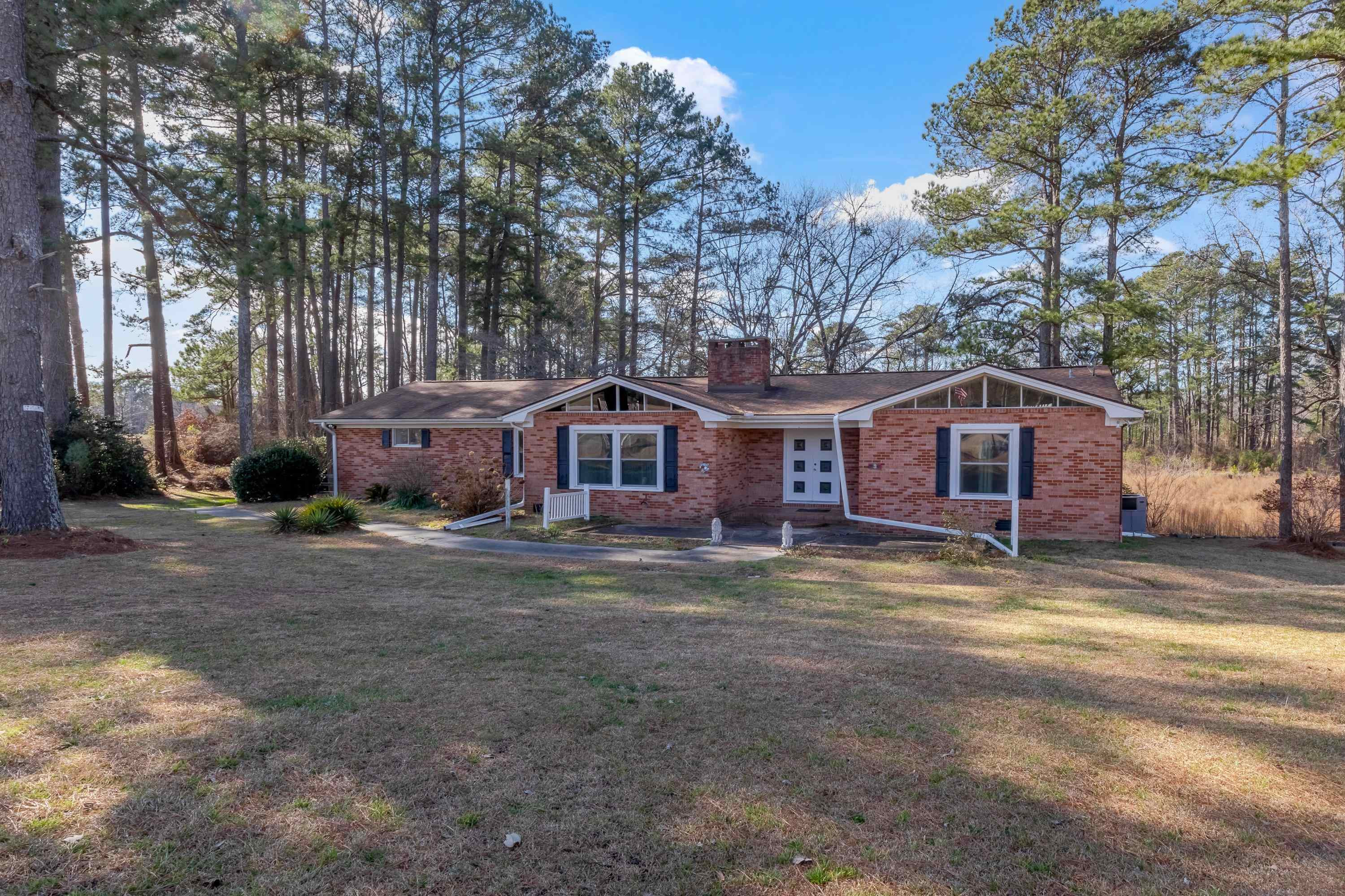 4612 Browns Pond Road Selma, NC 27576 - Photo 4 of 50 a wooden bench sitting in front of a house