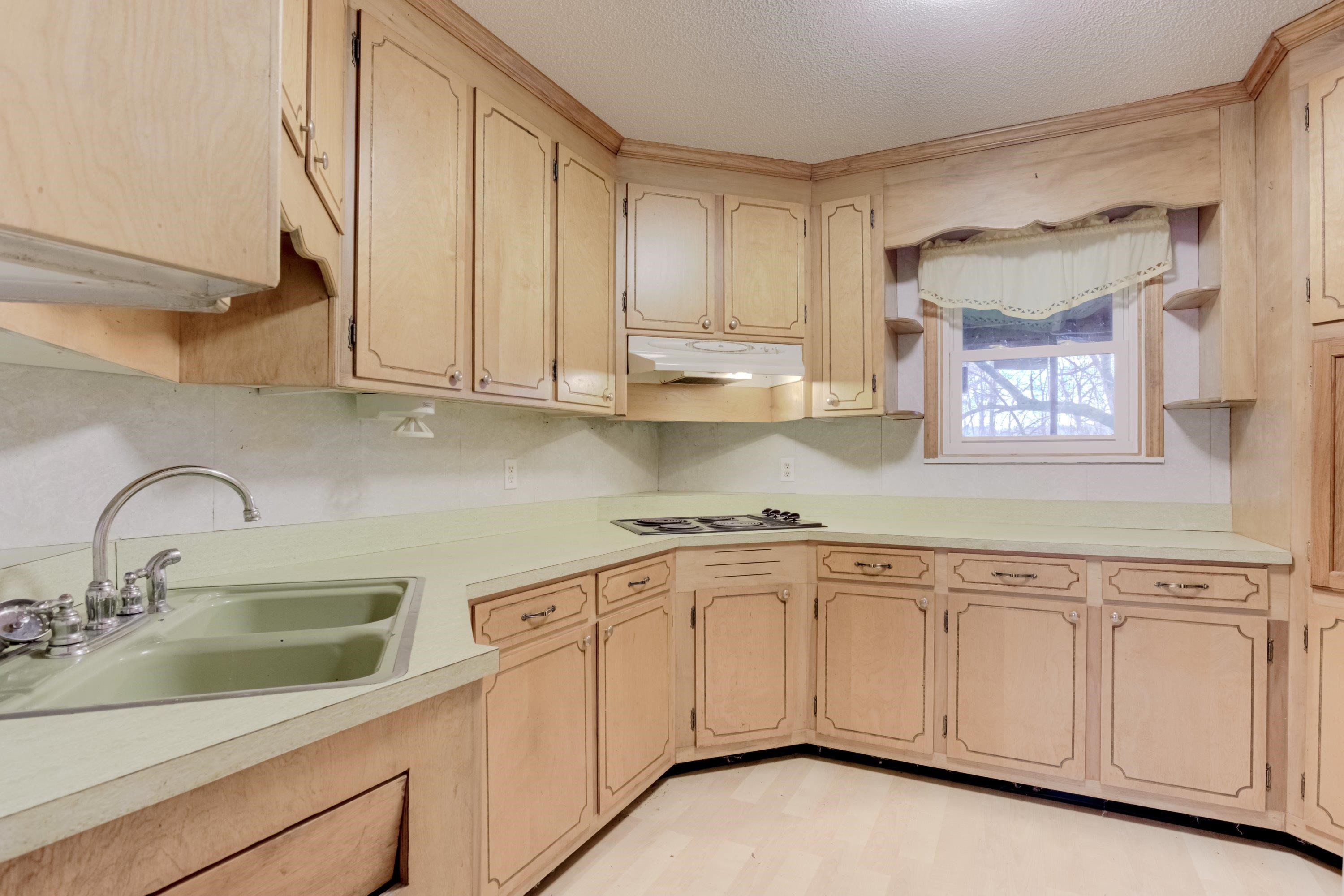4612 Browns Pond Road Selma, NC 27576 - Photo 10 of 50 a kitchen with white cabinets white appliances and sink