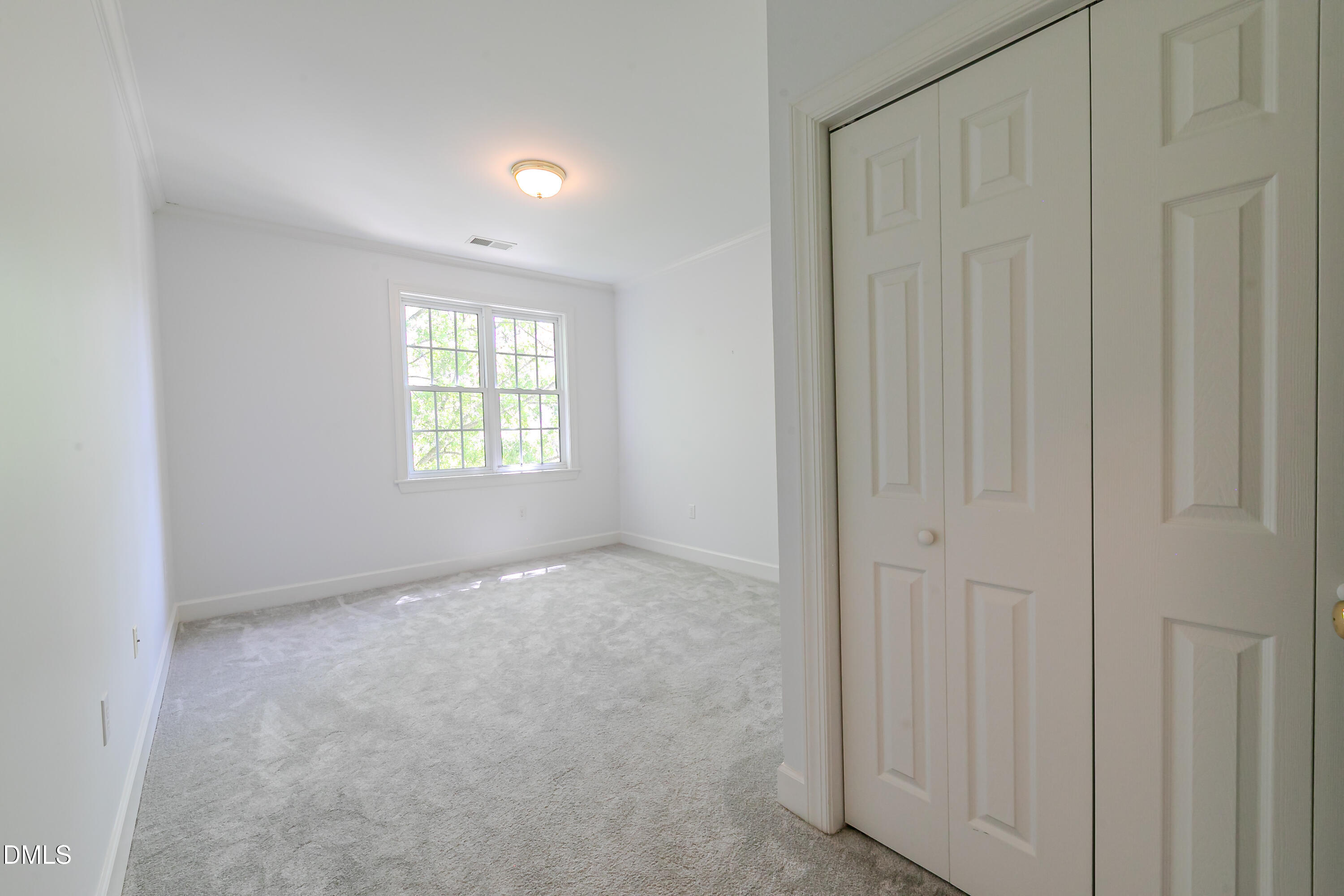 116 Northbrook Drive, Unit 305 Raleigh, NC 27609 - Photo 32 of 43 an empty room with windows
