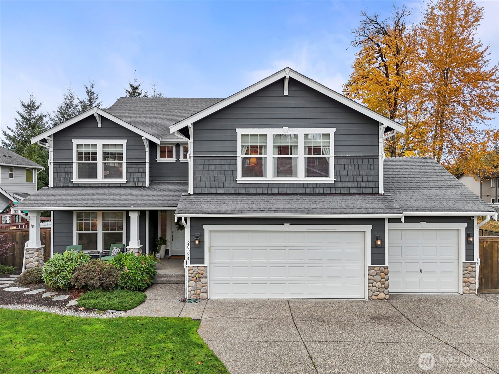 20024 Southeast 260th Place Covington, WA 98042 - Photo 1 of 40 a front view of a house with a yard and garage