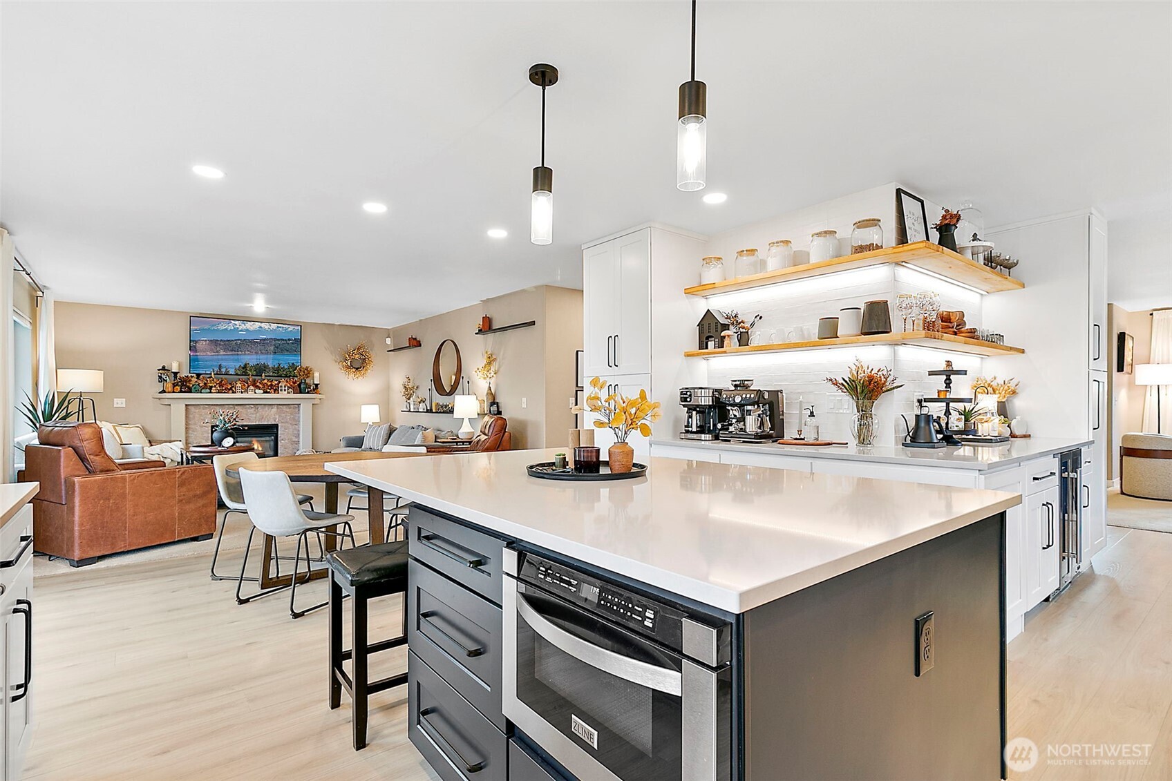 20024 Southeast 260th Place Covington, WA 98042 - Photo 16 of 40 a view of kitchen island with stainless steel appliances a table and chairs