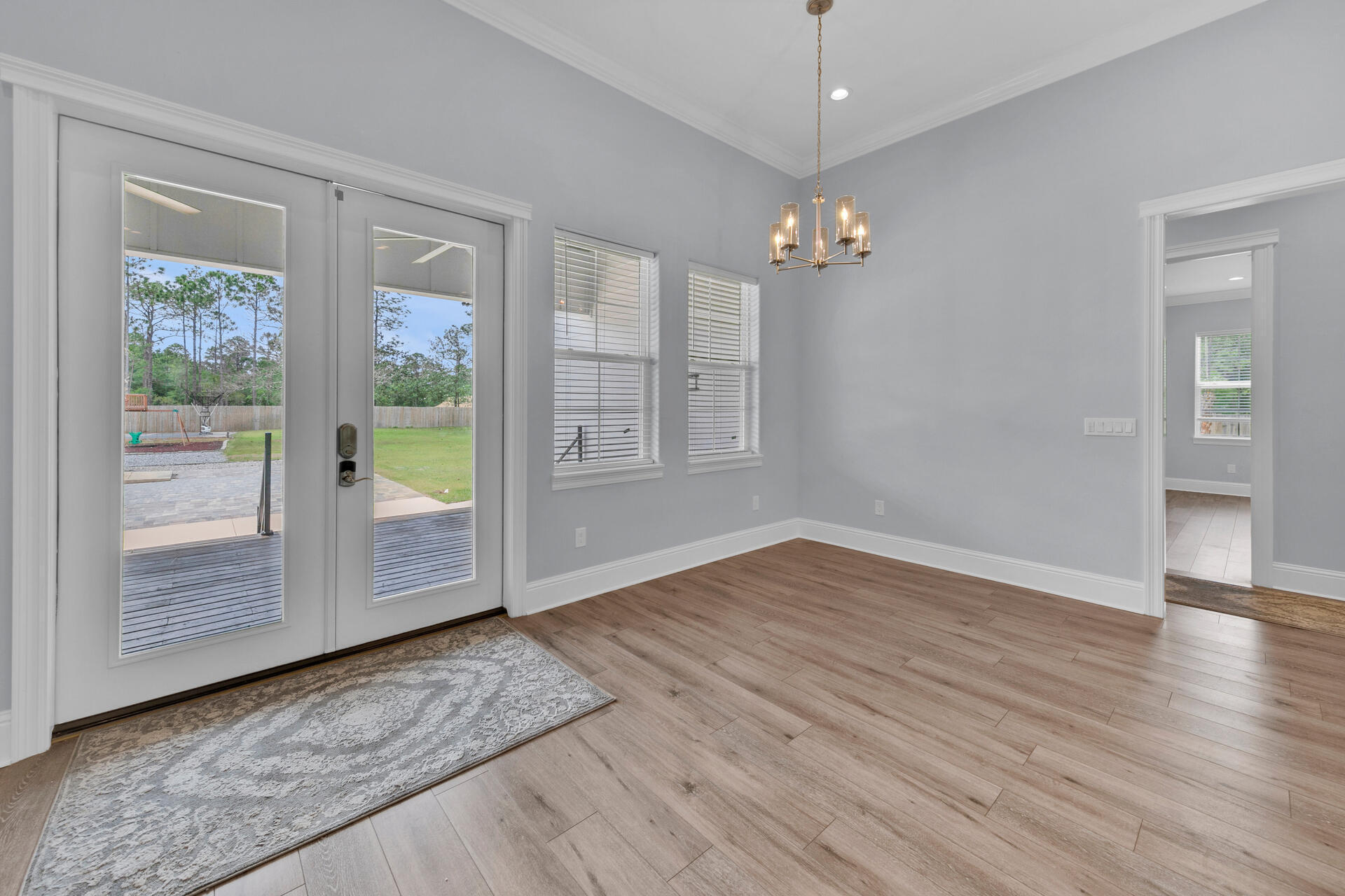 617 Churchill Bayou Road Santa Rosa Beach, FL 32459 - Photo 12 of 67 wooden floor in an empty room with a window