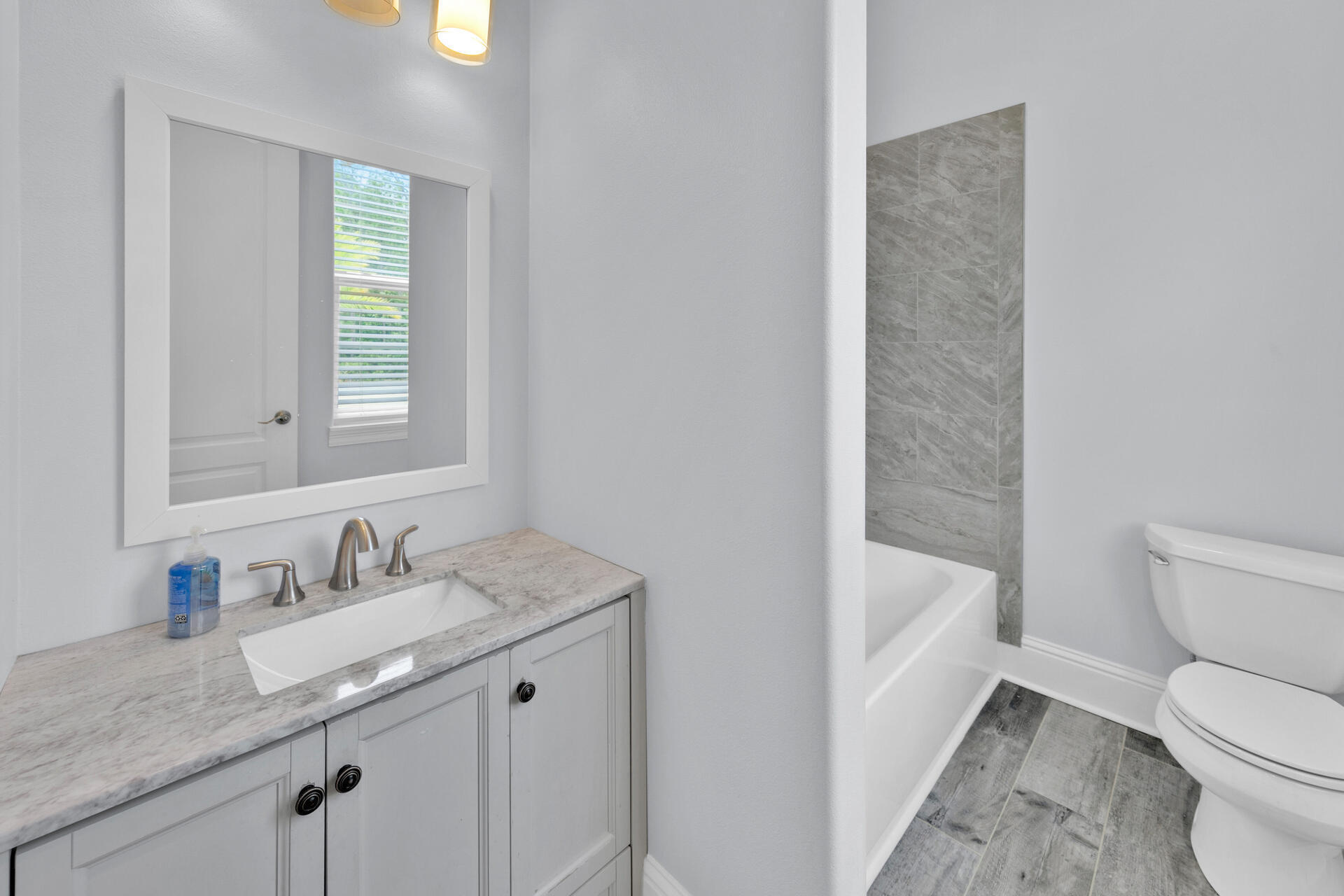 617 Churchill Bayou Road Santa Rosa Beach, FL 32459 - Photo 29 of 67 a bathroom with a granite countertop sink toilet and shower