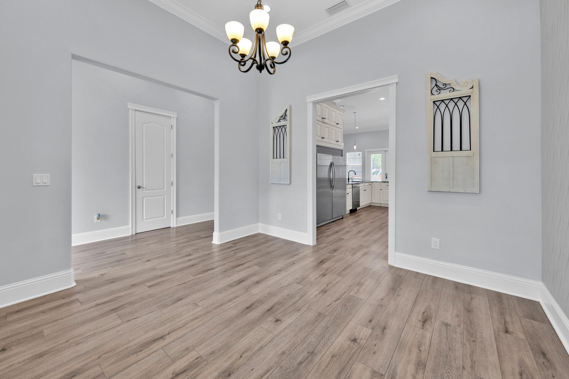 617 Churchill Bayou Road Santa Rosa Beach, FL 32459 - Photo 3 of 67 wooden floor in an empty room with a window