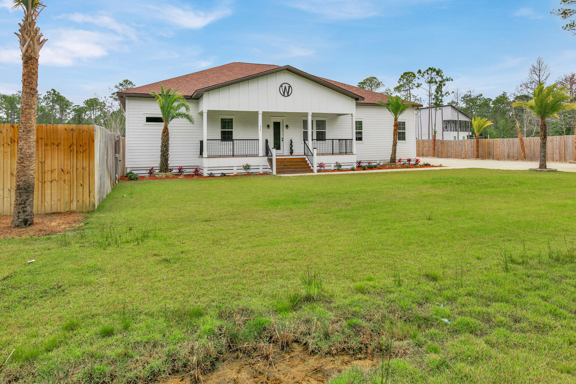 617 Churchill Bayou Road Santa Rosa Beach, FL 32459 - Photo 65 of 67 a front view of a house with garden
