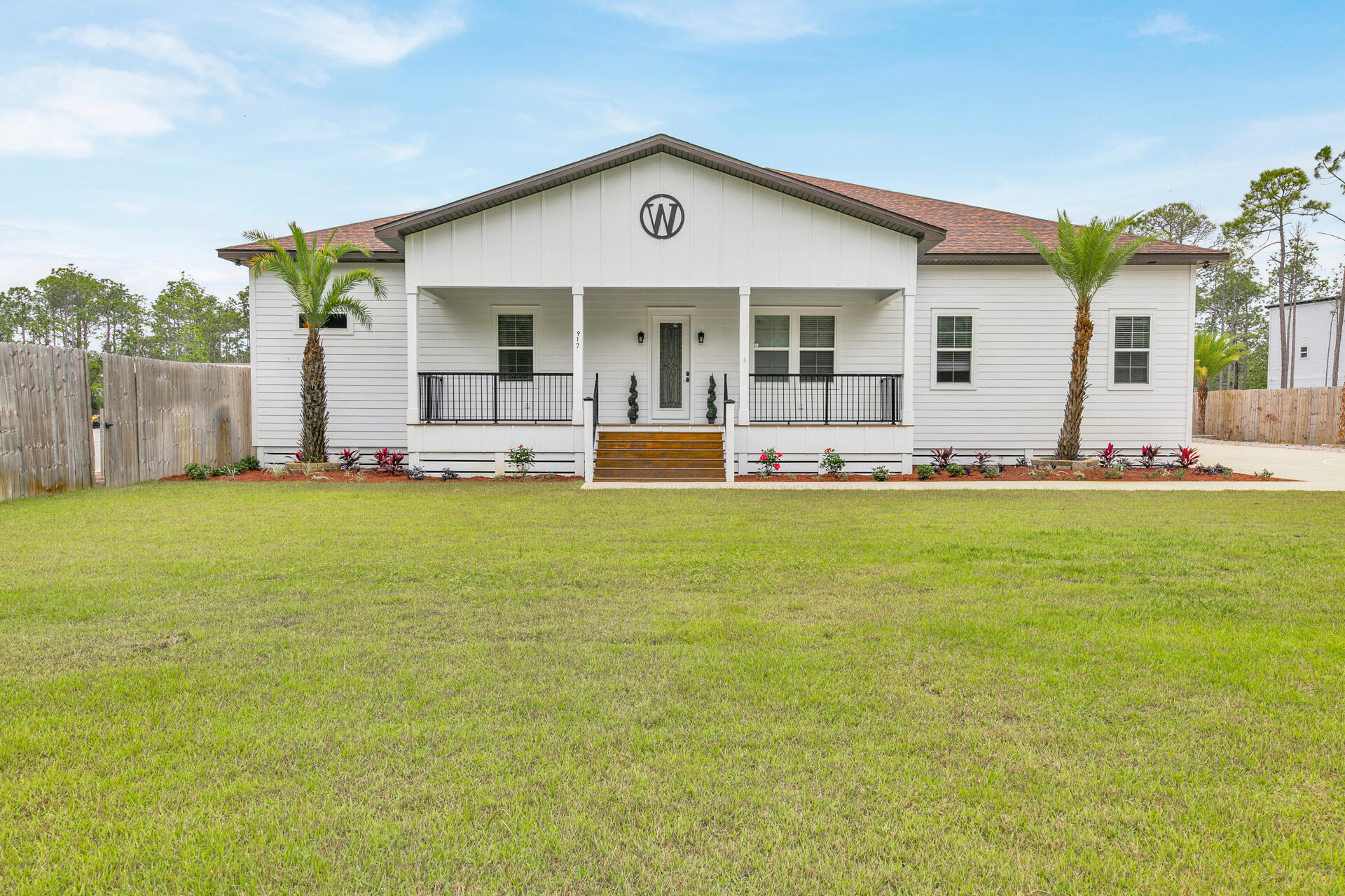617 Churchill Bayou Road Santa Rosa Beach, FL 32459 - Photo 67 of 67 a front view of a house with a garden and yard