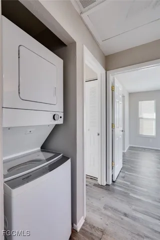 a utility room with wooden floor washer and dryer
