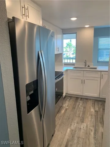 a kitchen with stainless steel appliances a refrigerator and a sink