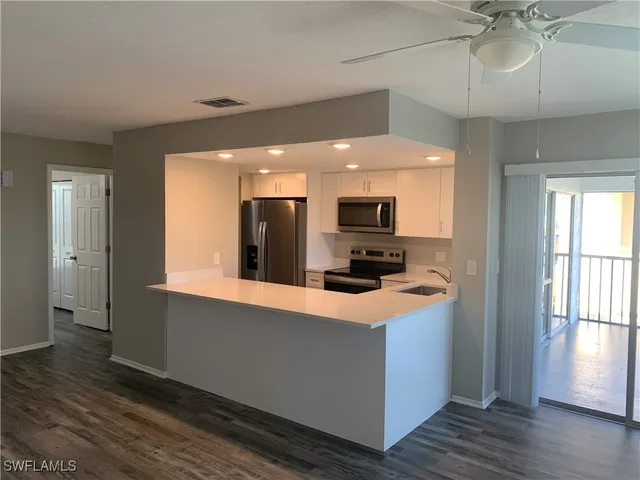 a kitchen with stainless steel appliances a microwave a stove and a refrigerator