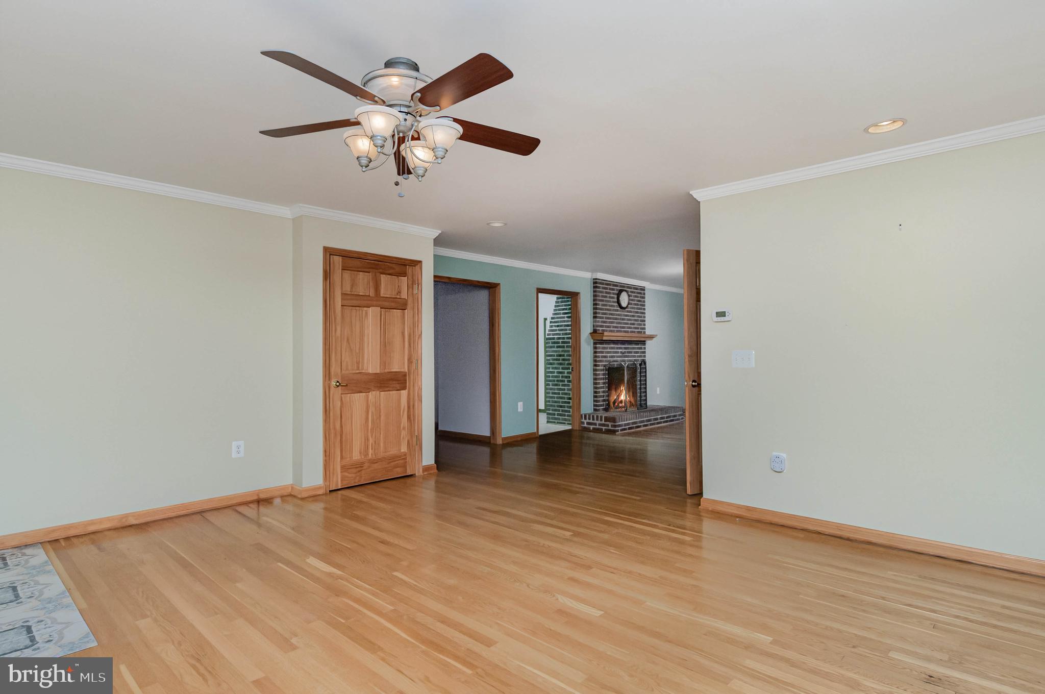 3116 Mt Carmel Road Upperco, MD 21155 - Photo 13 of 28 a view of an empty room with wooden floor and a ceiling fan