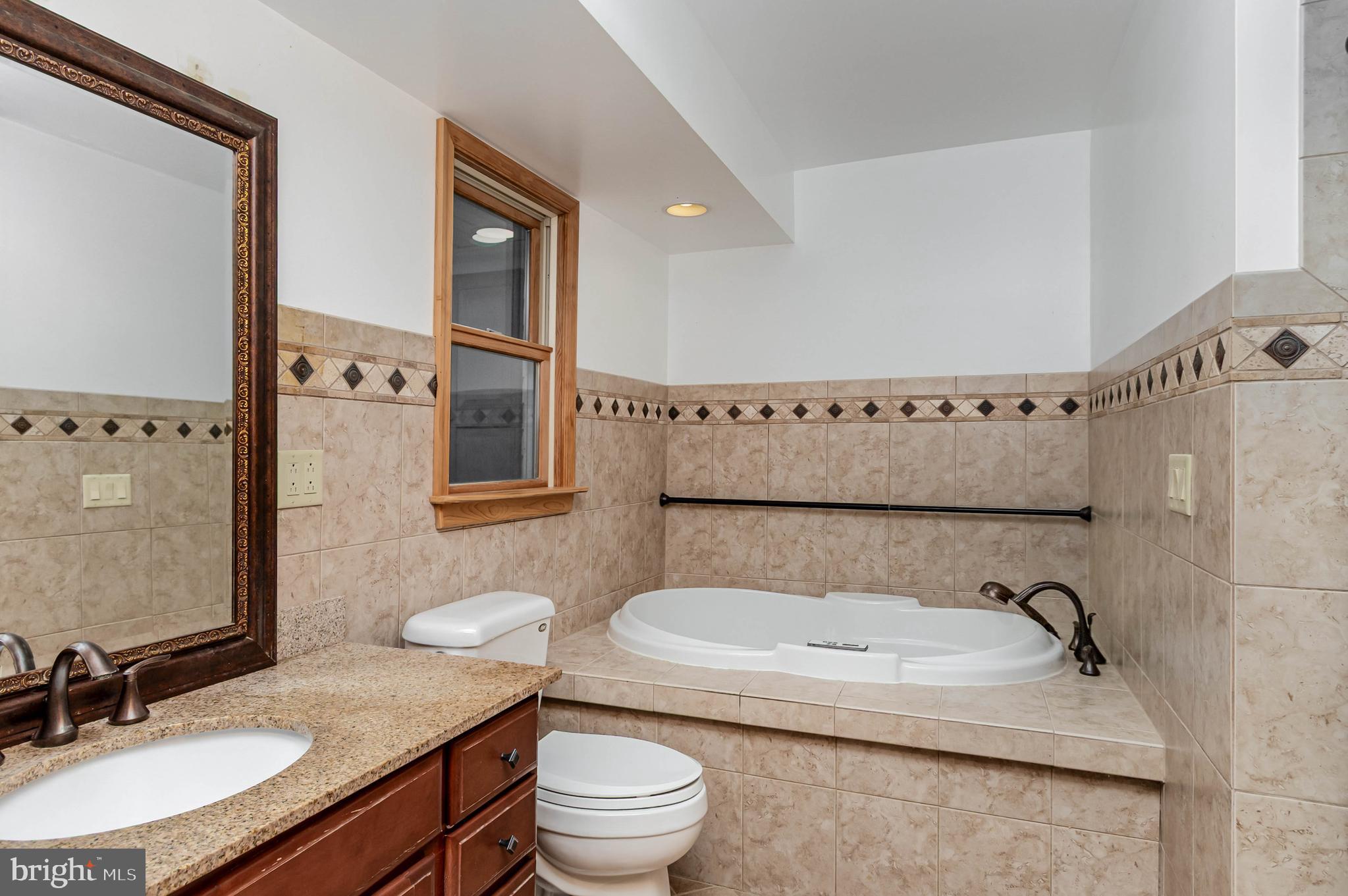 3116 Mt Carmel Road Upperco, MD 21155 - Photo 19 of 28 a bathroom with a granite countertop sink mirror vanity and toilet