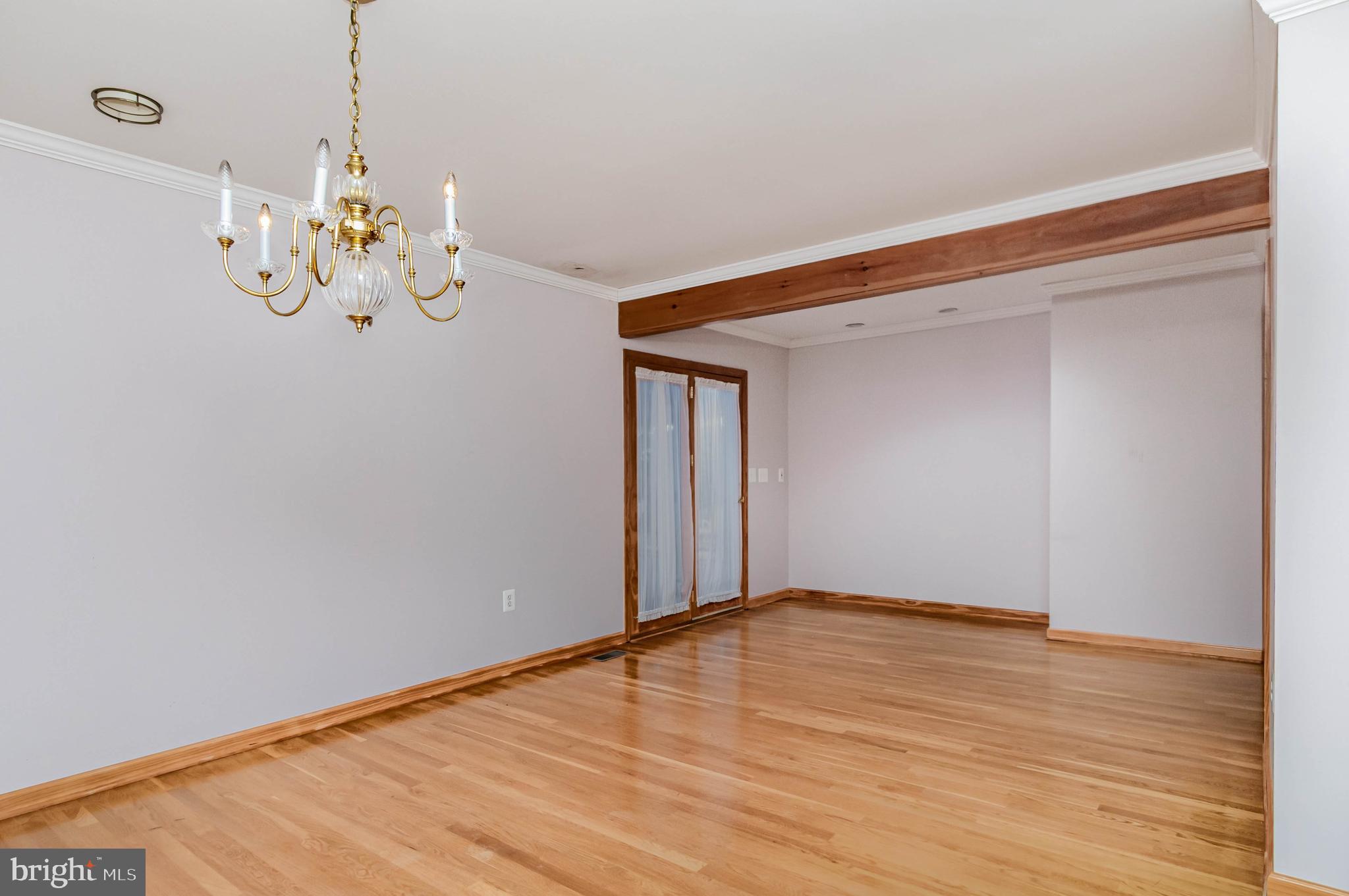 3116 Mt Carmel Road Upperco, MD 21155 - Photo 20 of 28 a view of an empty room with wooden floor and chandelier