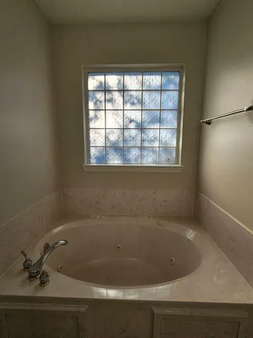 a bath tub sitting next to a window