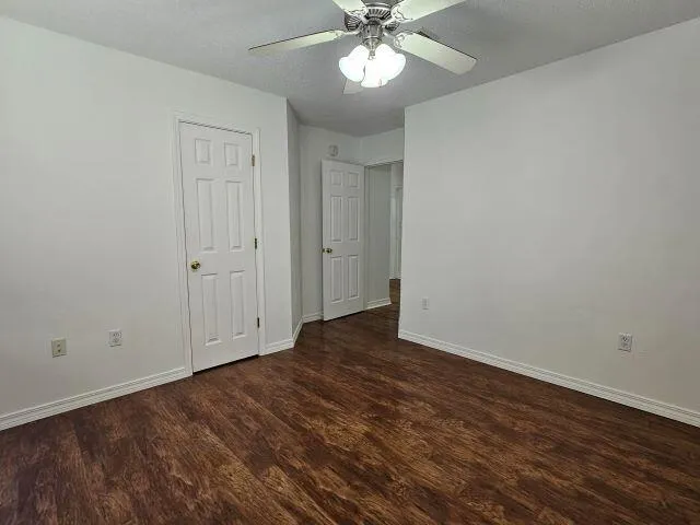 a view of an empty room and wooden floor