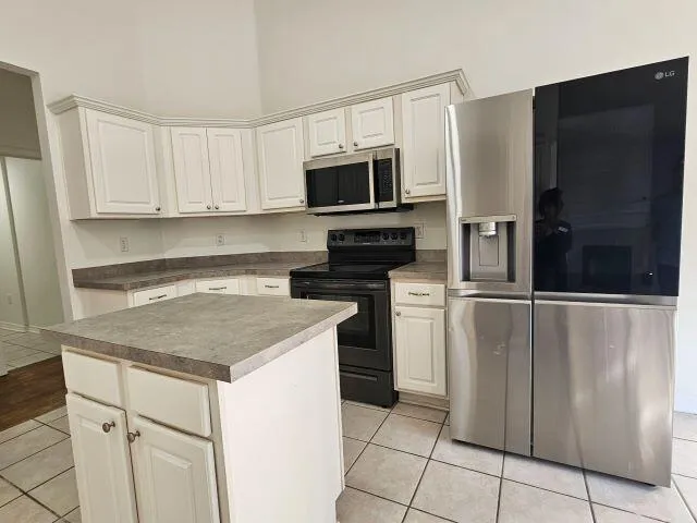 a kitchen with appliances a sink and cabinets