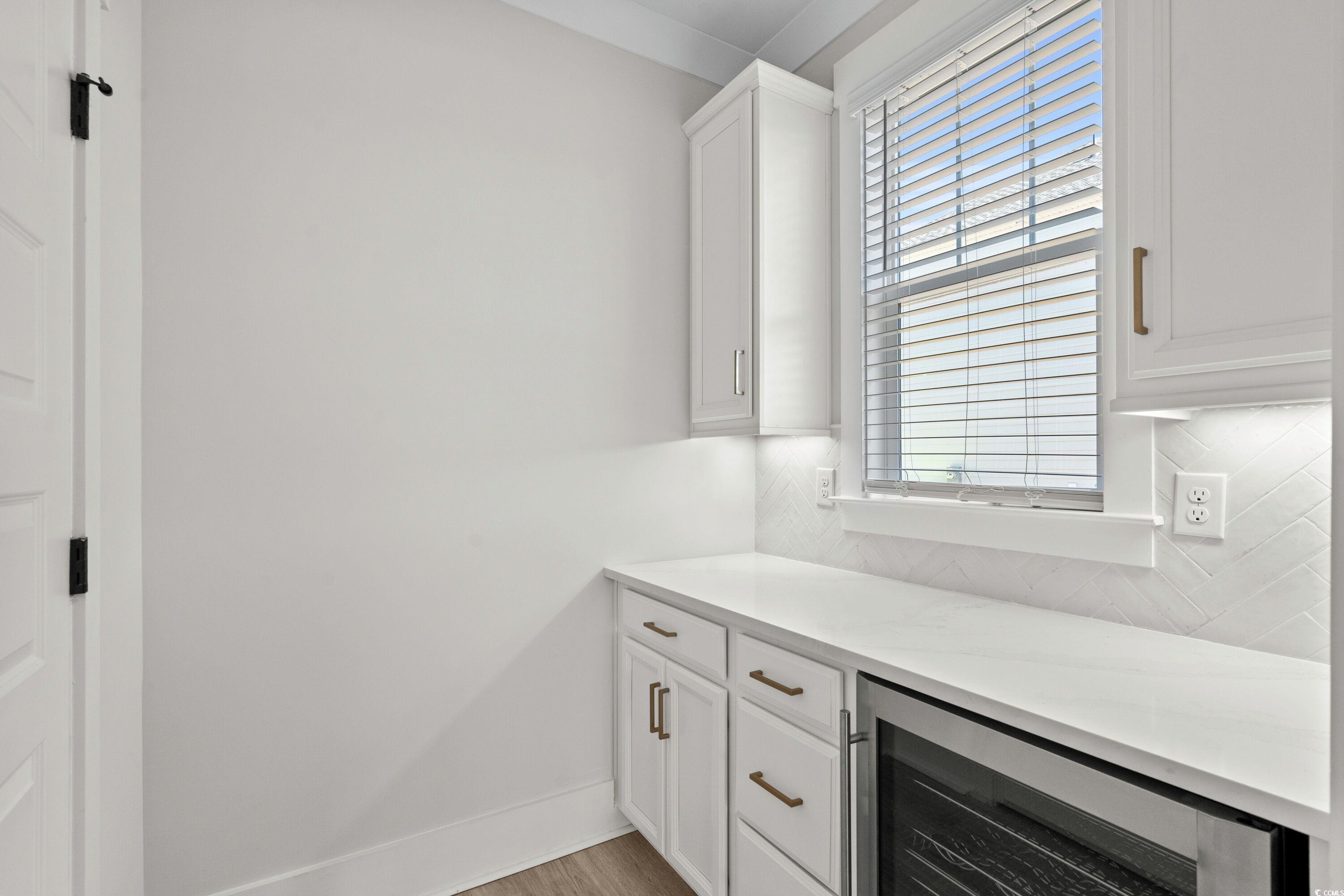 9035 Binnicker Drive Murrells Inlet, SC 29576 - Photo 13 of 40 Bar featuring light wood-style floors, beverage cooler, baseboards, and decorative backsplash