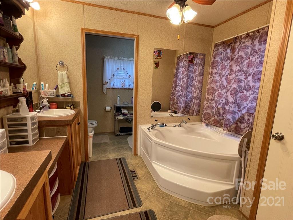 158 Doster Road Lancaster, SC 29720 - Photo 17 of 18 a bathroom with a tub sink and mirror