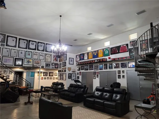 a kitchen with stainless steel appliances granite countertop a table chairs and a refrigerator