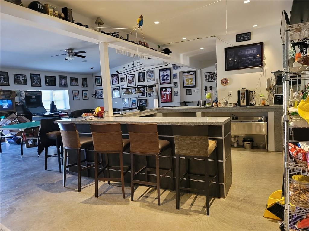35 Washington Lake Road Eldred, NY 12732 - Photo 24 of 35 a kitchen with stainless steel appliances granite countertop a table chairs and a refrigerator