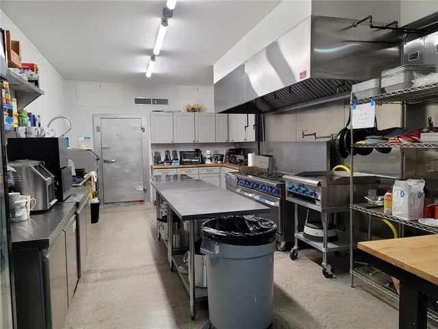 a kitchen with a table chairs stove and microwave