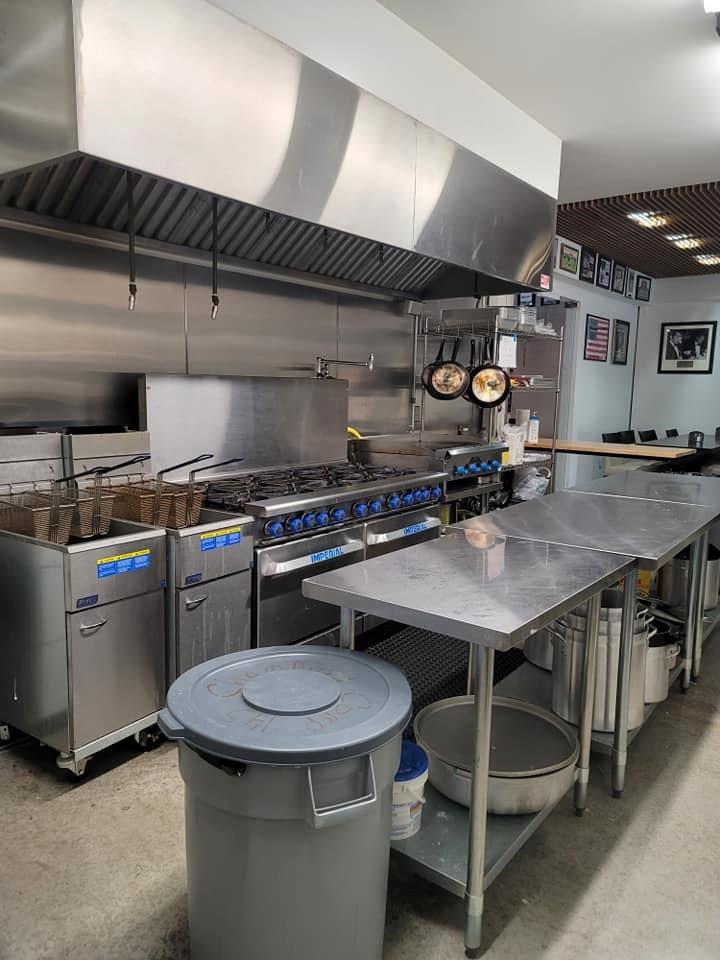 35 Washington Lake Road Eldred, NY 12732 - Photo 27 of 35 a kitchen with a table chairs stove and microwave