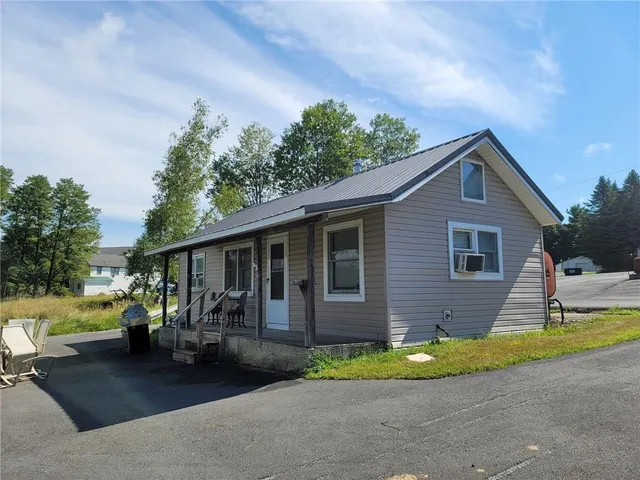 a view of a house with a backyard
