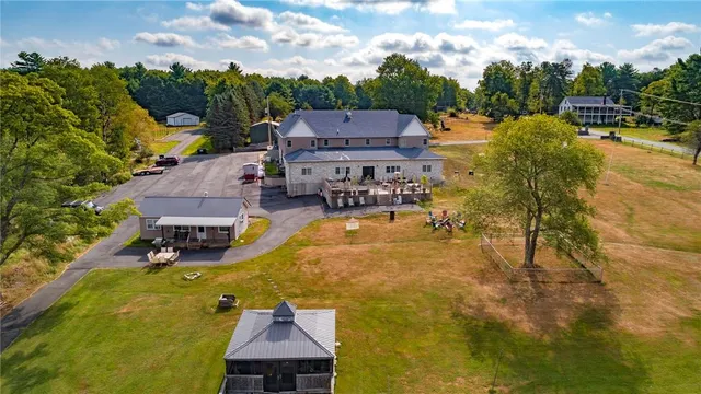 a swimming pool with outdoor seating and yard