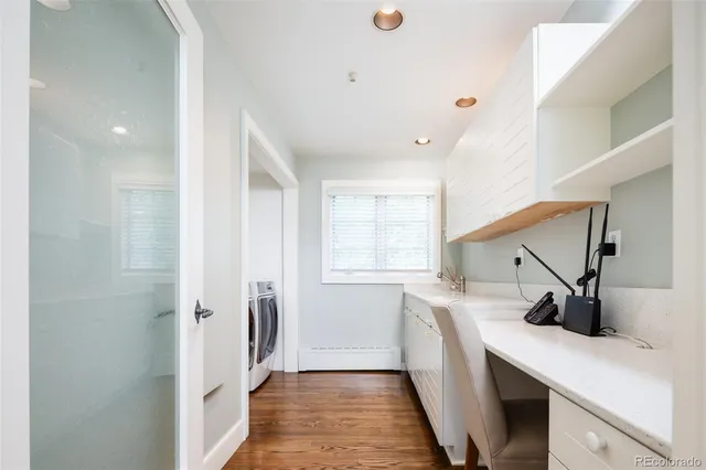 a bathroom with a glass shower door and a sink