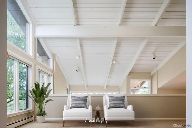 a living room with furniture and kitchen view