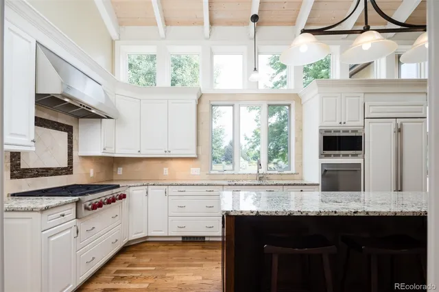 a living room with furniture kitchen view and a fireplace