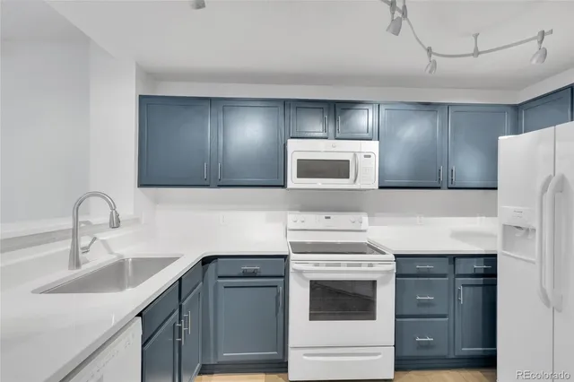 a kitchen with a sink cabinets and stainless steel appliances