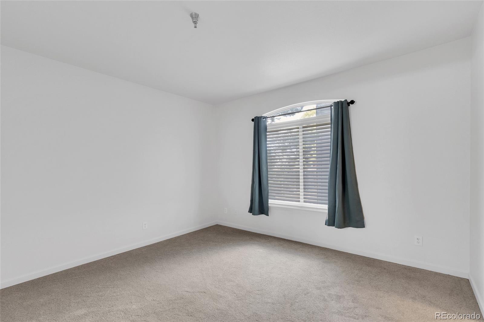 2575 South Syracuse Way, Unit G104 Denver, CO 80231 - Photo 12 of 20 an empty room with windows