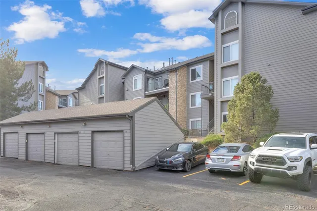 a couple of cars parked in front of a house