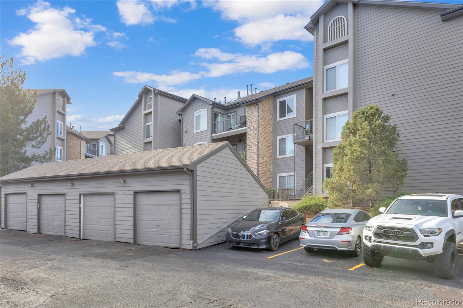2575 South Syracuse Way, Unit G104 Denver, CO 80231 - Photo 18 of 20 a couple of cars parked in front of a house