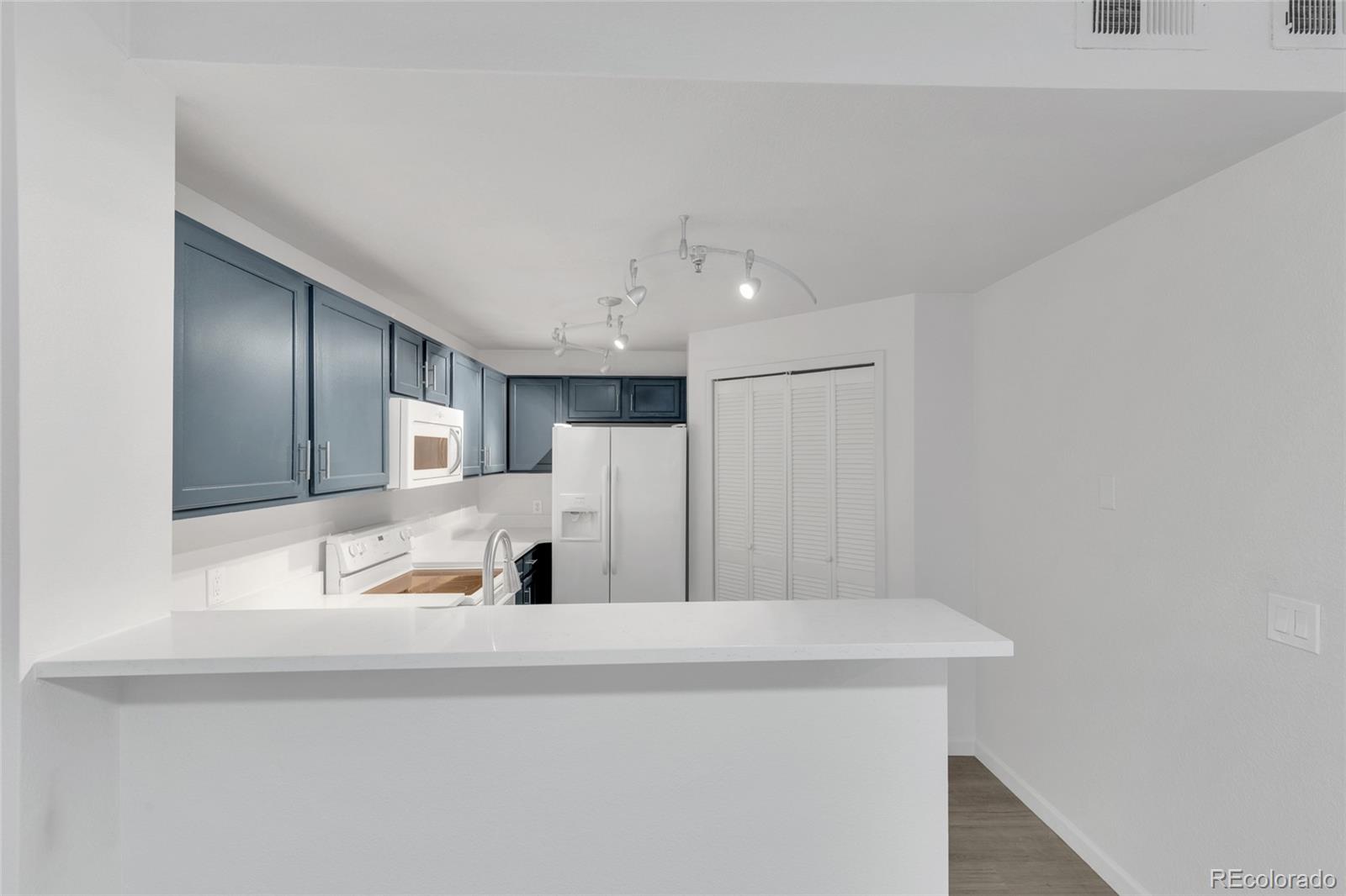 2575 South Syracuse Way, Unit G104 Denver, CO 80231 - Photo 4 of 20 a view of a kitchen with a sink