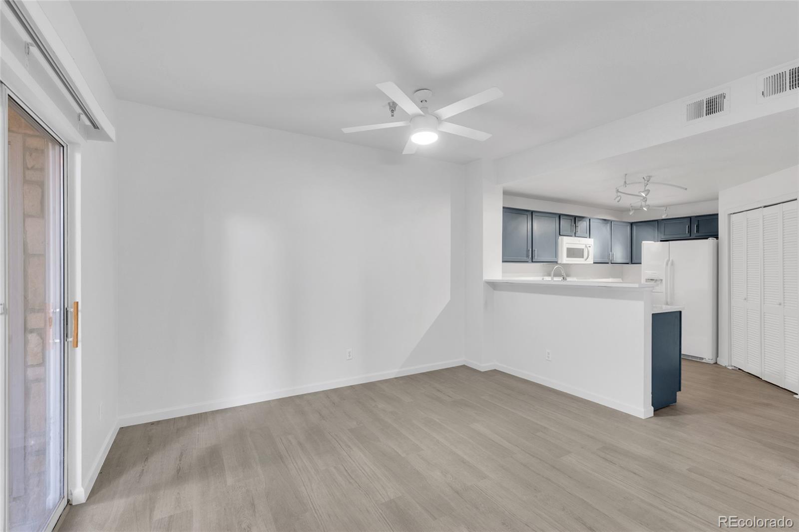 2575 South Syracuse Way, Unit G104 Denver, CO 80231 - Photo 6 of 20 a view of a kitchen with a sink and a window