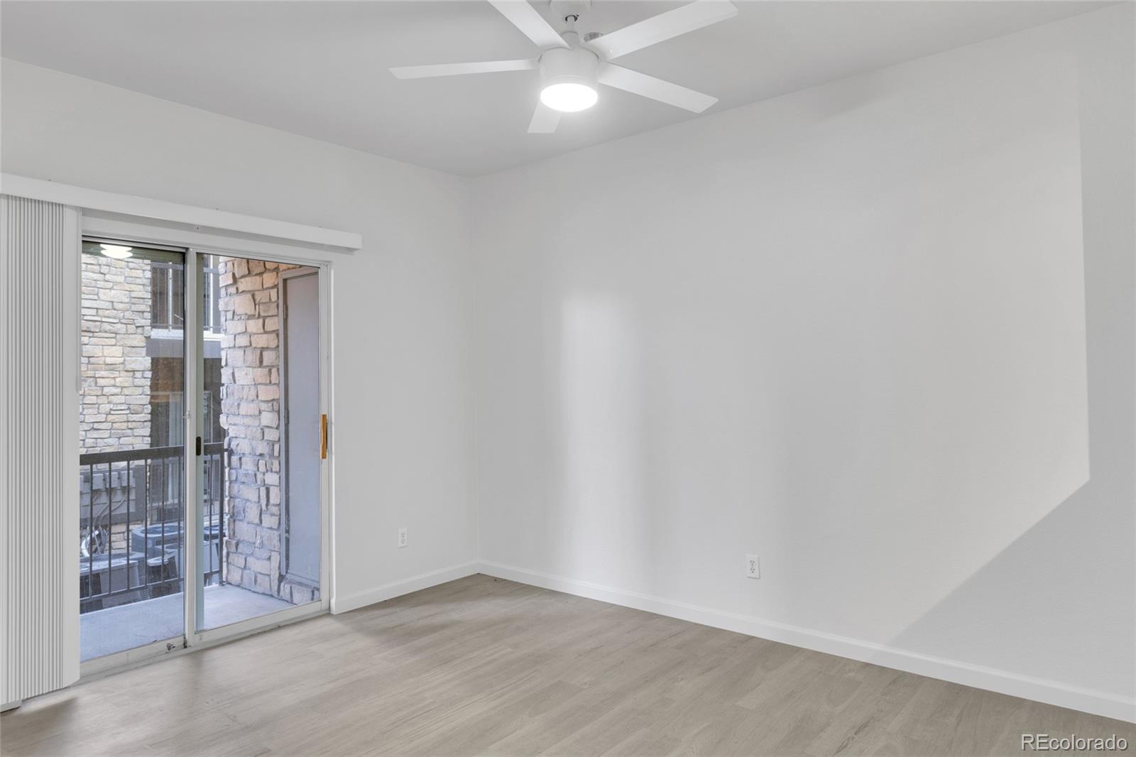 2575 South Syracuse Way, Unit G104 Denver, CO 80231 - Photo 7 of 20 wooden floor in an empty room with a window