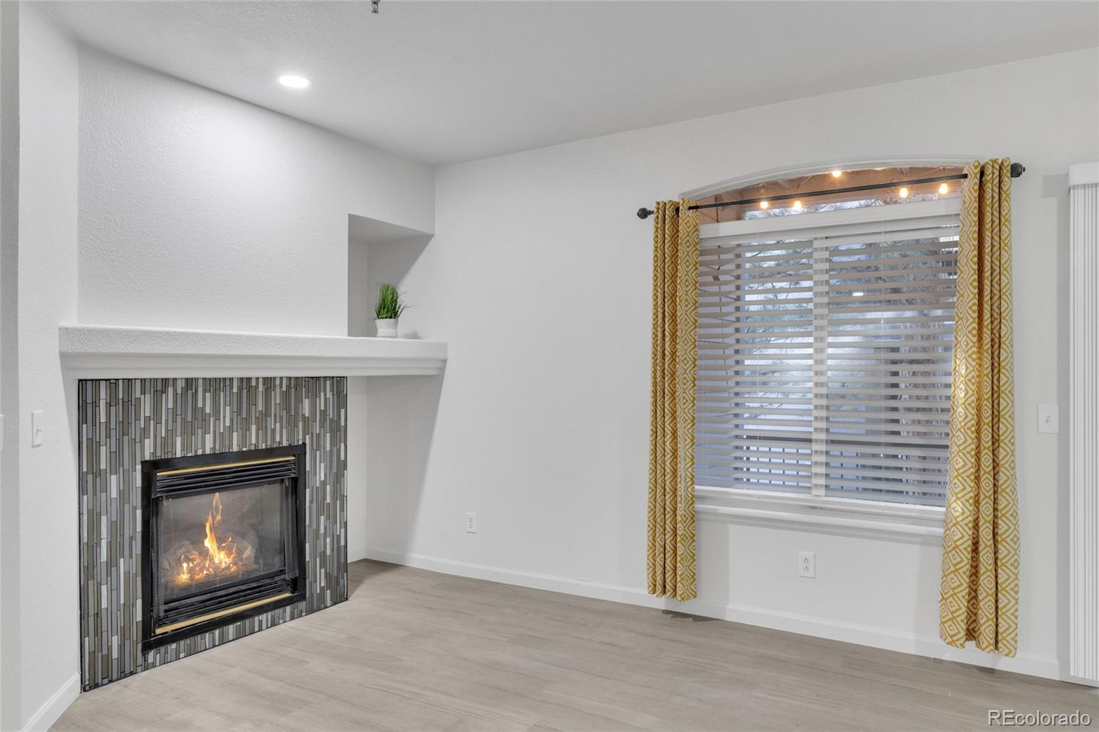 2575 South Syracuse Way, Unit G104 Denver, CO 80231 - Photo 8 of 20 a room with a fireplace