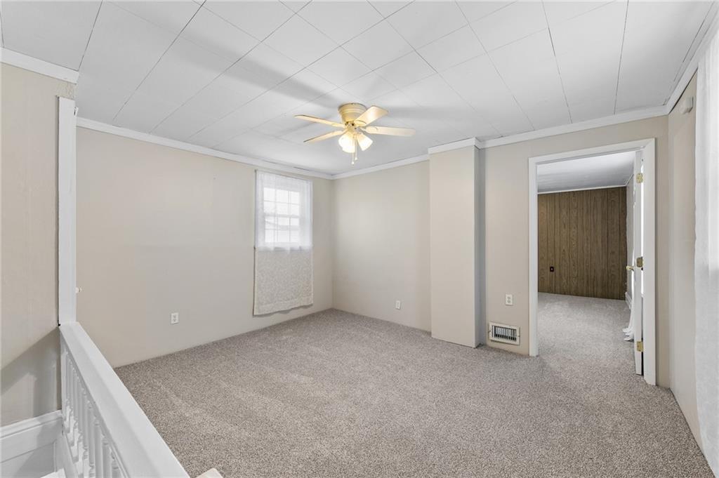 807 Oak Street Monessen, PA 15062 - Photo 11 of 28 an empty room with closet and a chandelier fan