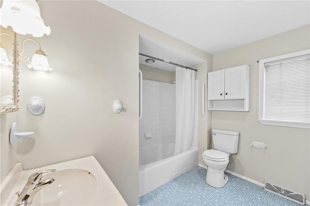 807 Oak Street Monessen, PA 15062 - Photo 13 of 28 a white toilet sitting next to a bathroom sink